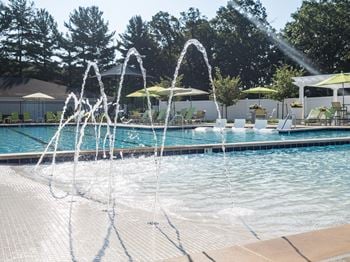 Beach entry swimming pool with sun shelf and splash pad